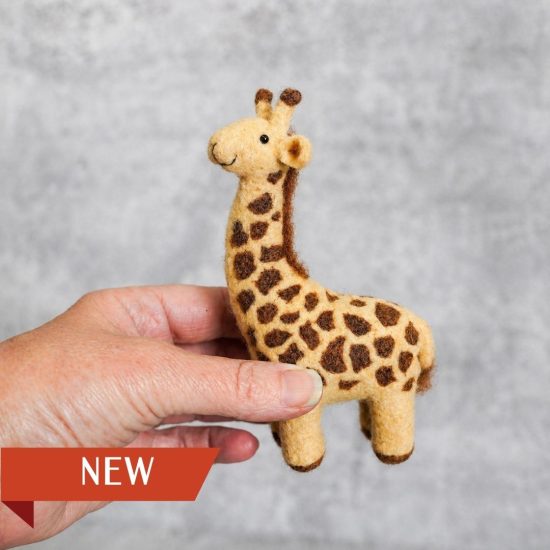 hand holding needle felted giraffe
