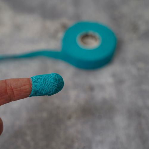 Thimble Tape – Reusable Needle Felting Finger Protector shown wrapped on finger