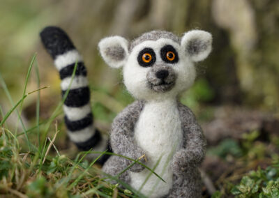 needle felted lemur by a tree